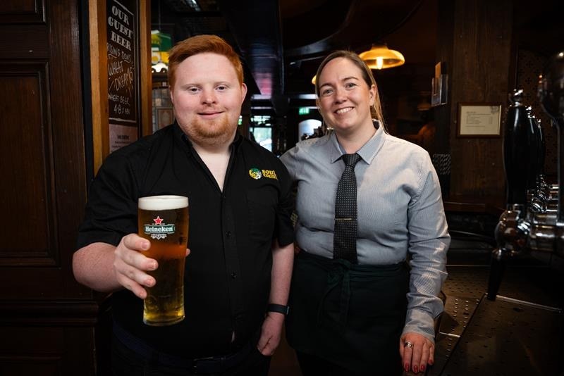 Dylan and Sarah behind the bar at the South County